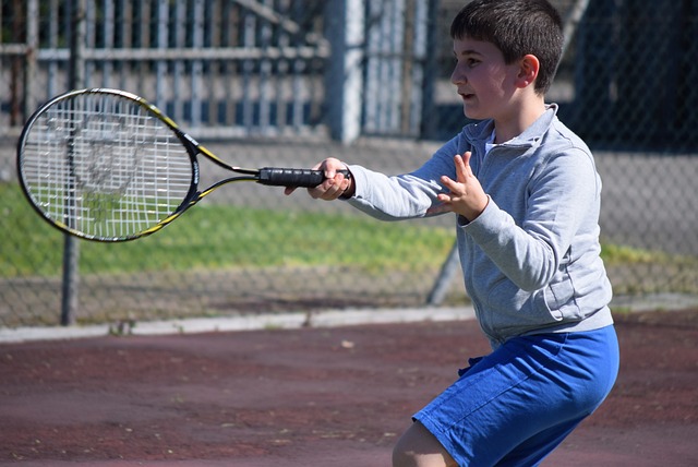 Child learning tennis at summer camp Hexham Tennis Club